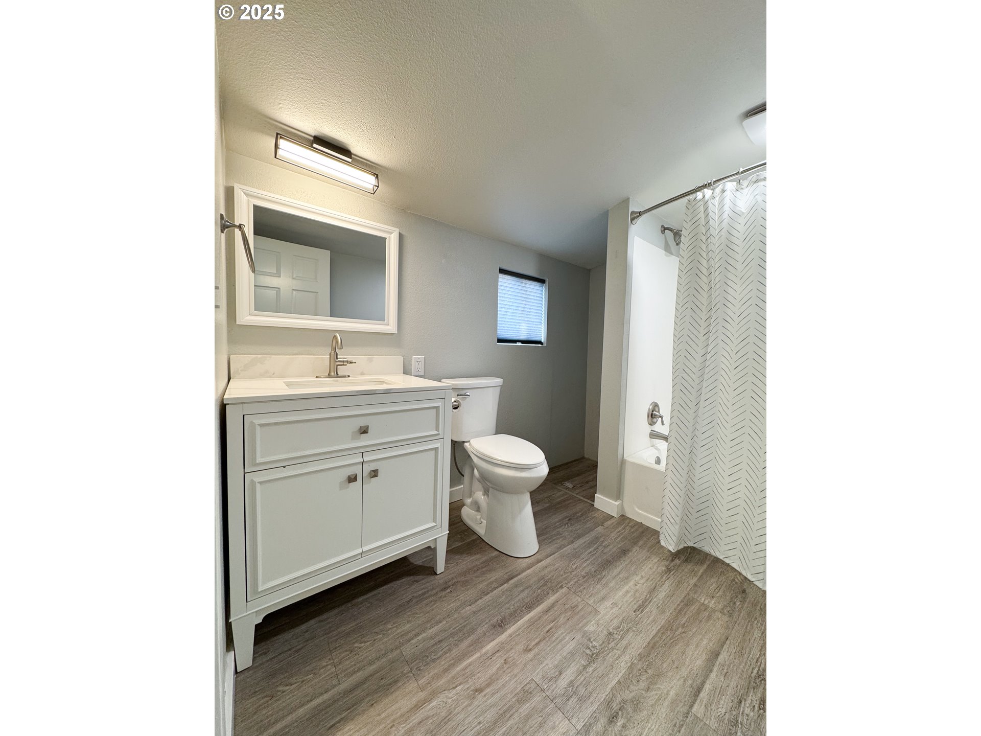 971 Walnut Street Baker City, OR 97814 - Photo 14 of 19 a spacious bathroom with a toilet sink and mirror