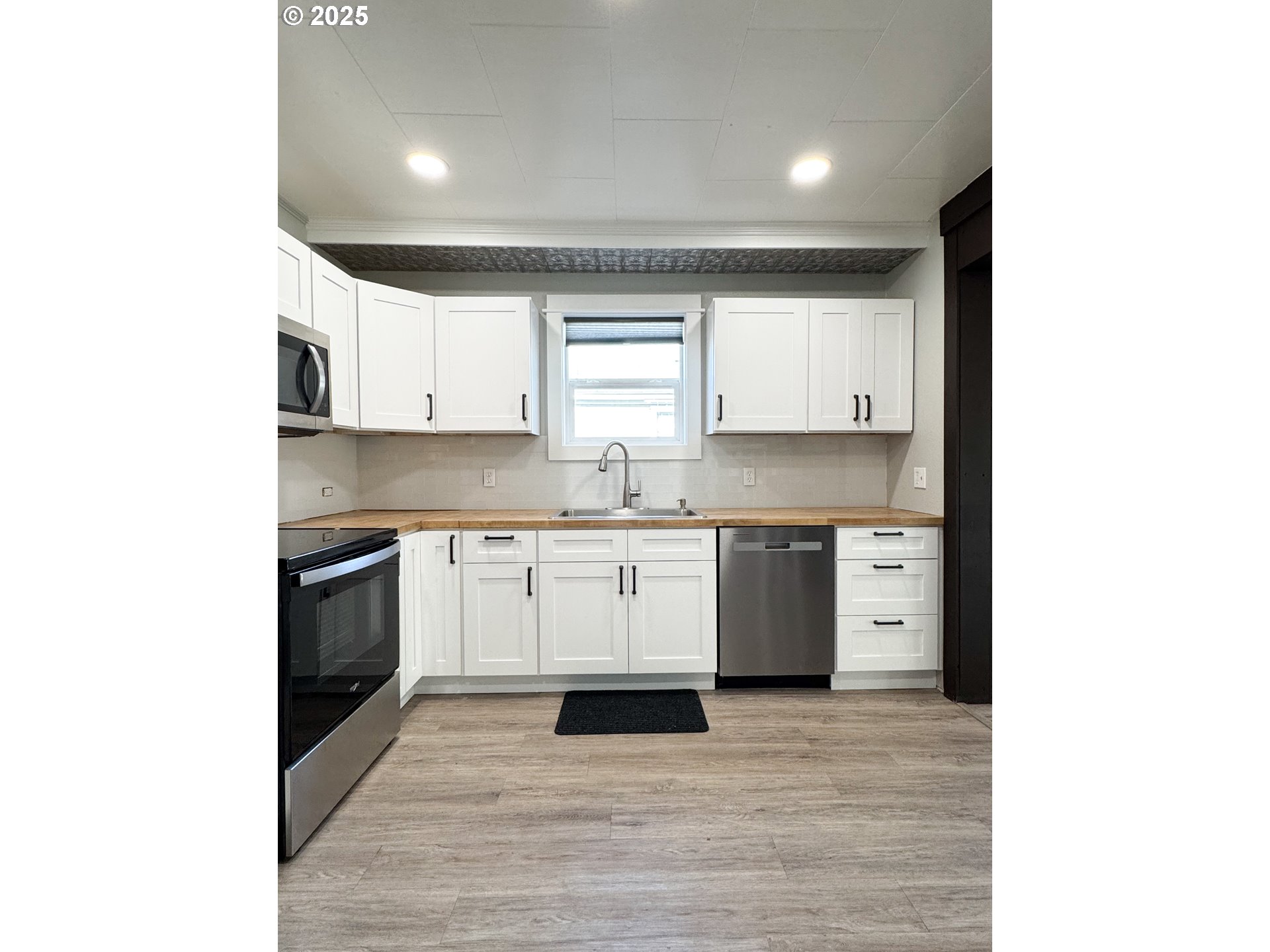 971 Walnut Street Baker City, OR 97814 - Photo 7 of 19 a kitchen with granite countertop a sink cabinets and stainless steel appliances