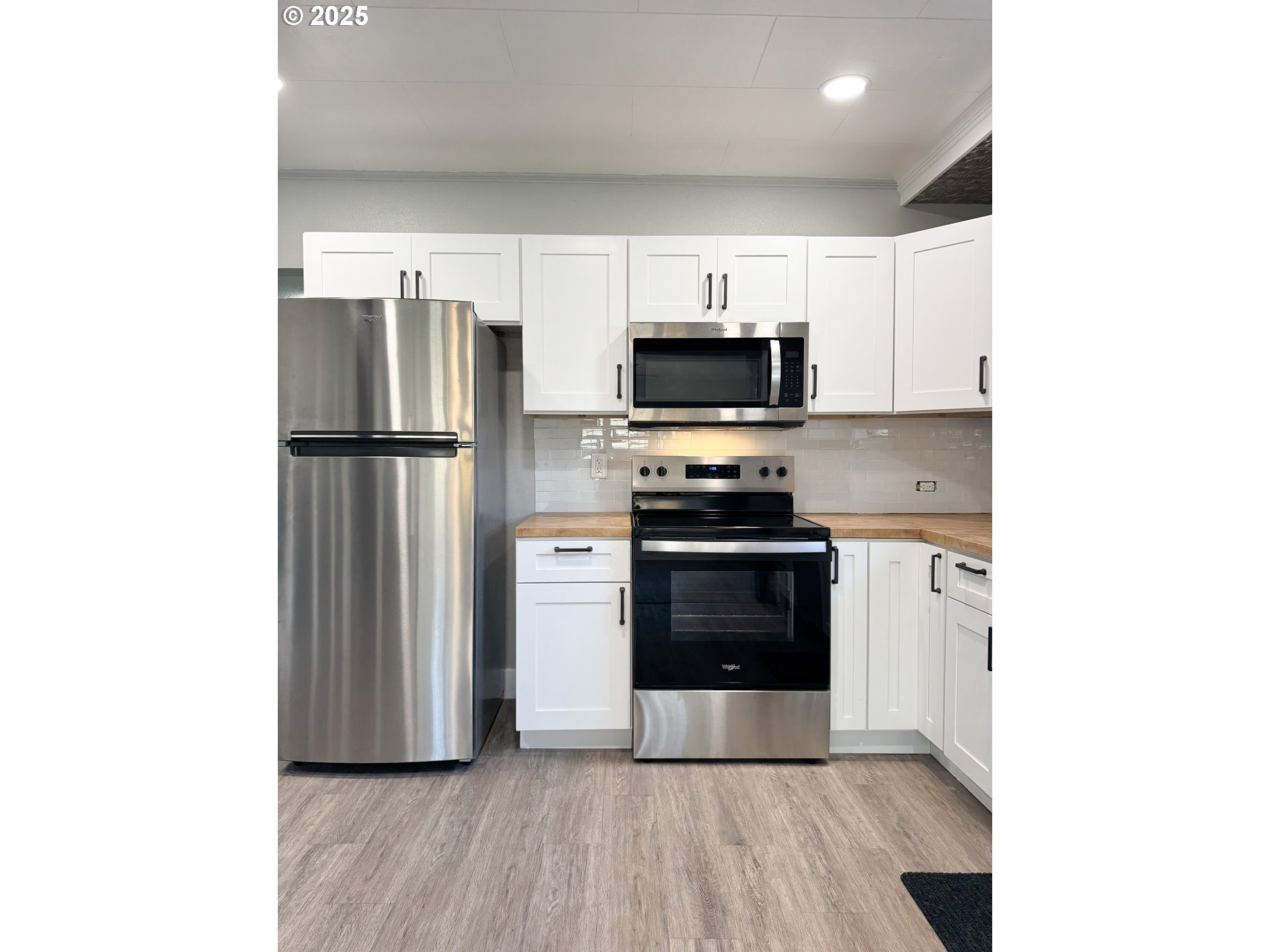 971 Walnut Street Baker City, OR 97814 - Photo 8 of 19 a kitchen with stainless steel appliances a refrigerator stove and microwave