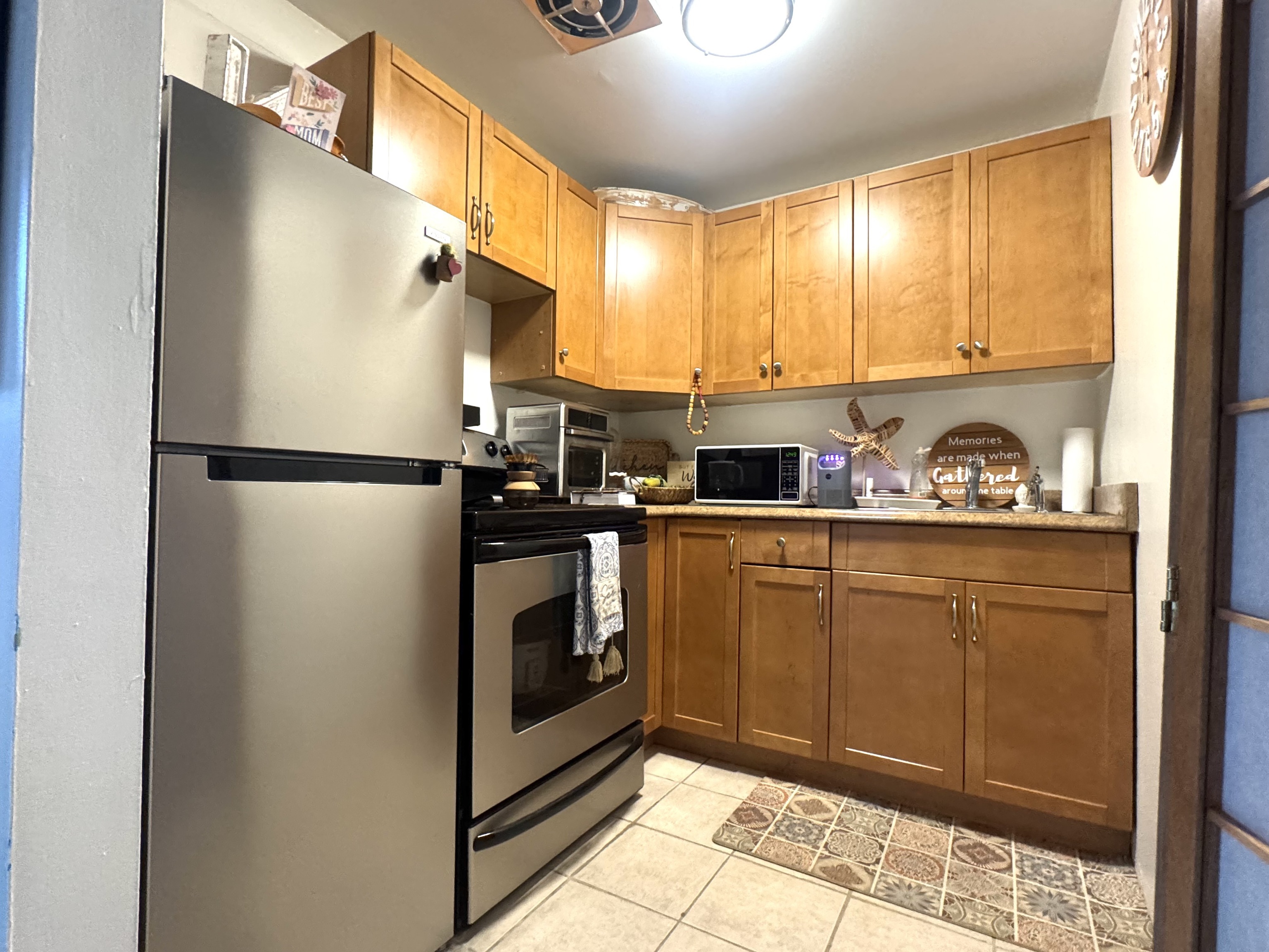 a kitchen with stainless steel appliances a refrigerator sink and cabinets