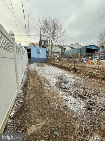 a backyard of a house with barbeque oven