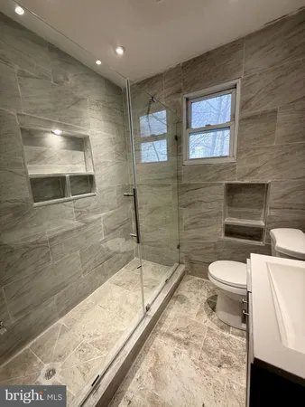 a bathroom with a toilet and a shower