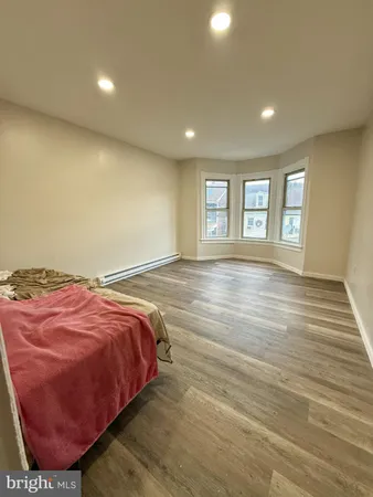 a bed sitting in a room next to a window