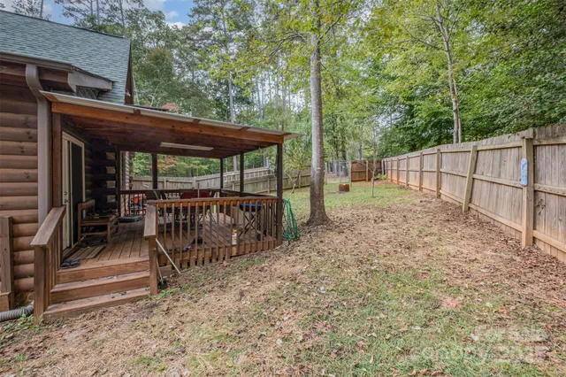 a view of a backyard with a garden and trees