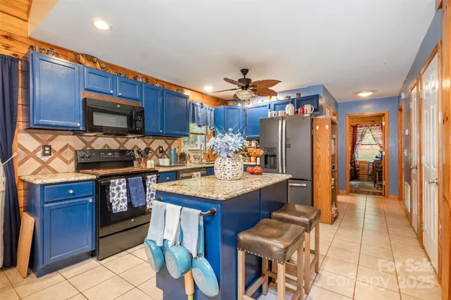 a kitchen with a stove a refrigerator and wooden cabinets