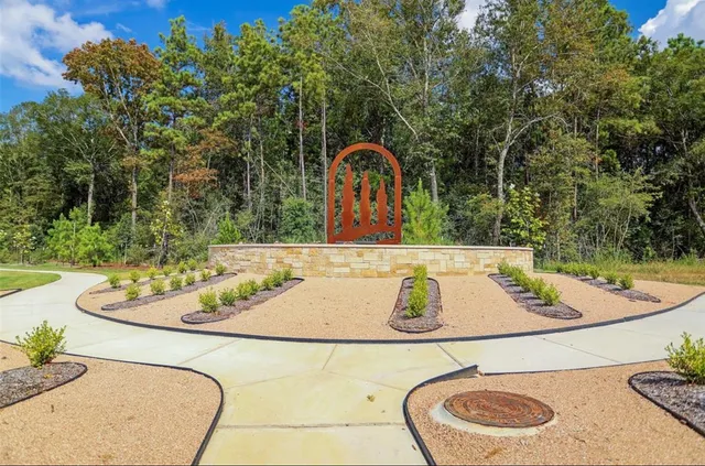 a view of a swimming pool with a table and chairs under an umbrella