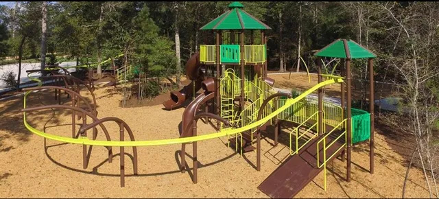 a kitchen with stainless steel appliances a refrigerator a stove a dining table and chairs