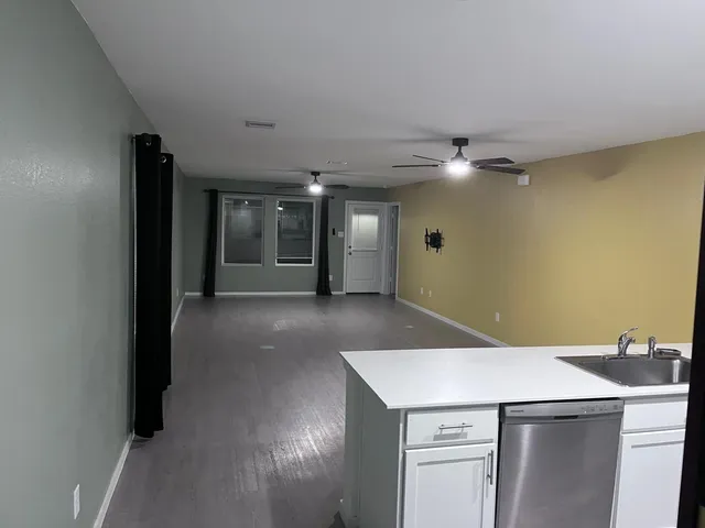 a view of a kitchen with a sink and a refrigerator