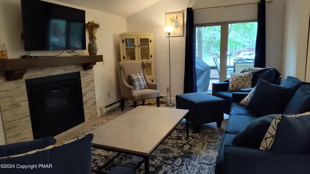 a living room with furniture wooden floor and a fireplace
