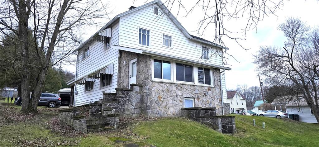 64 Old Rte 36 Road Punxsutawney, PA 15767 - Photo 2 of 12 a front view of a house with a yard