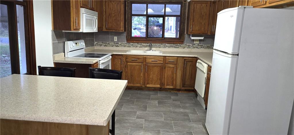 64 Old Rte 36 Road Punxsutawney, PA 15767 - Photo 4 of 12 a kitchen with stainless steel appliances a refrigerator sink and cabinets