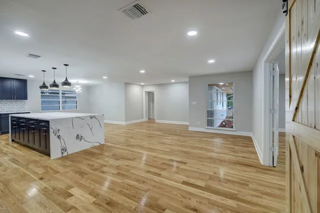 a spacious bedroom with a bed and a table in it