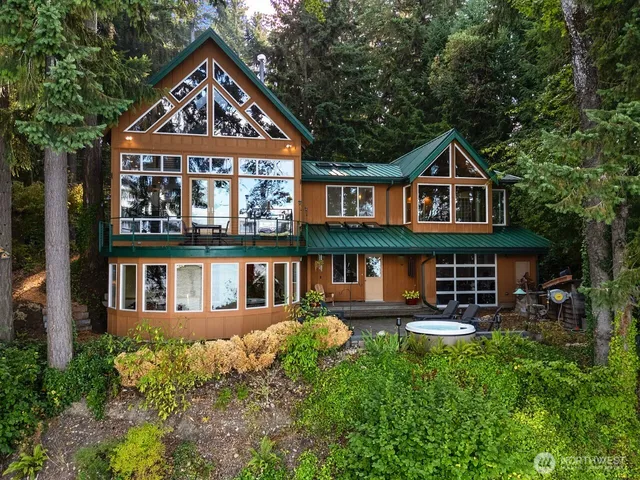 an aerial view of a house with swimming pool and garden