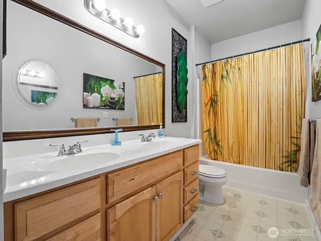a bathroom with a sink vanity and a mirror