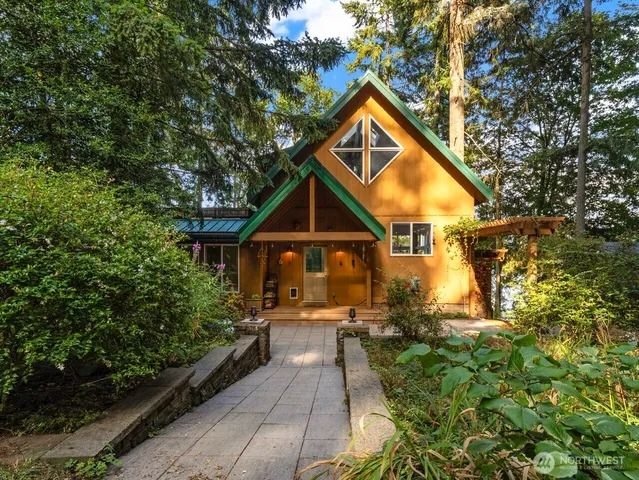 a view of a house with backyard and sitting area
