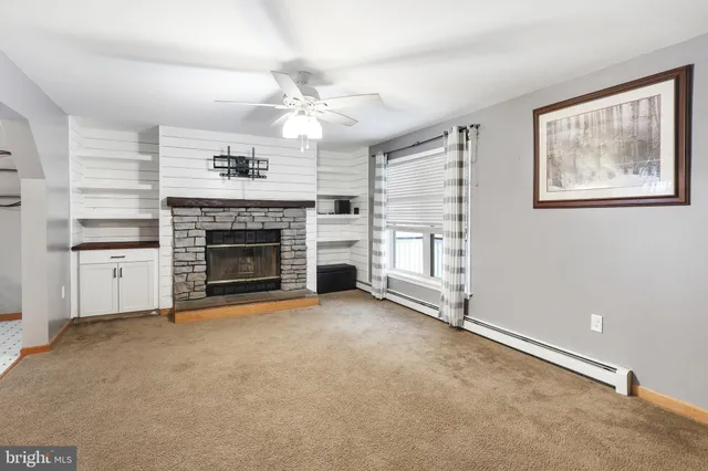 a living room with furniture and a fireplace