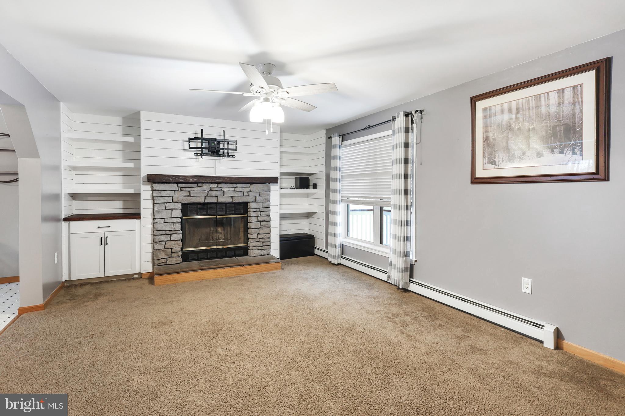 2021 Frostburg Road Frostburg, MD 21532 - Photo 15 of 67 an empty room with windows fireplace and fan