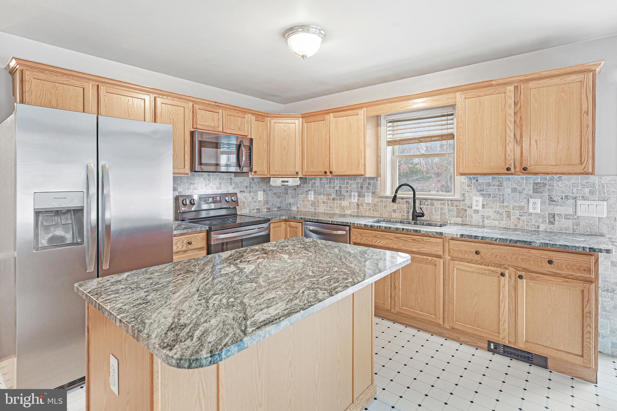2021 Frostburg Road Frostburg, MD 21532 - Photo 20 of 67 a kitchen with stainless steel appliances granite countertop a sink refrigerator and cabinets