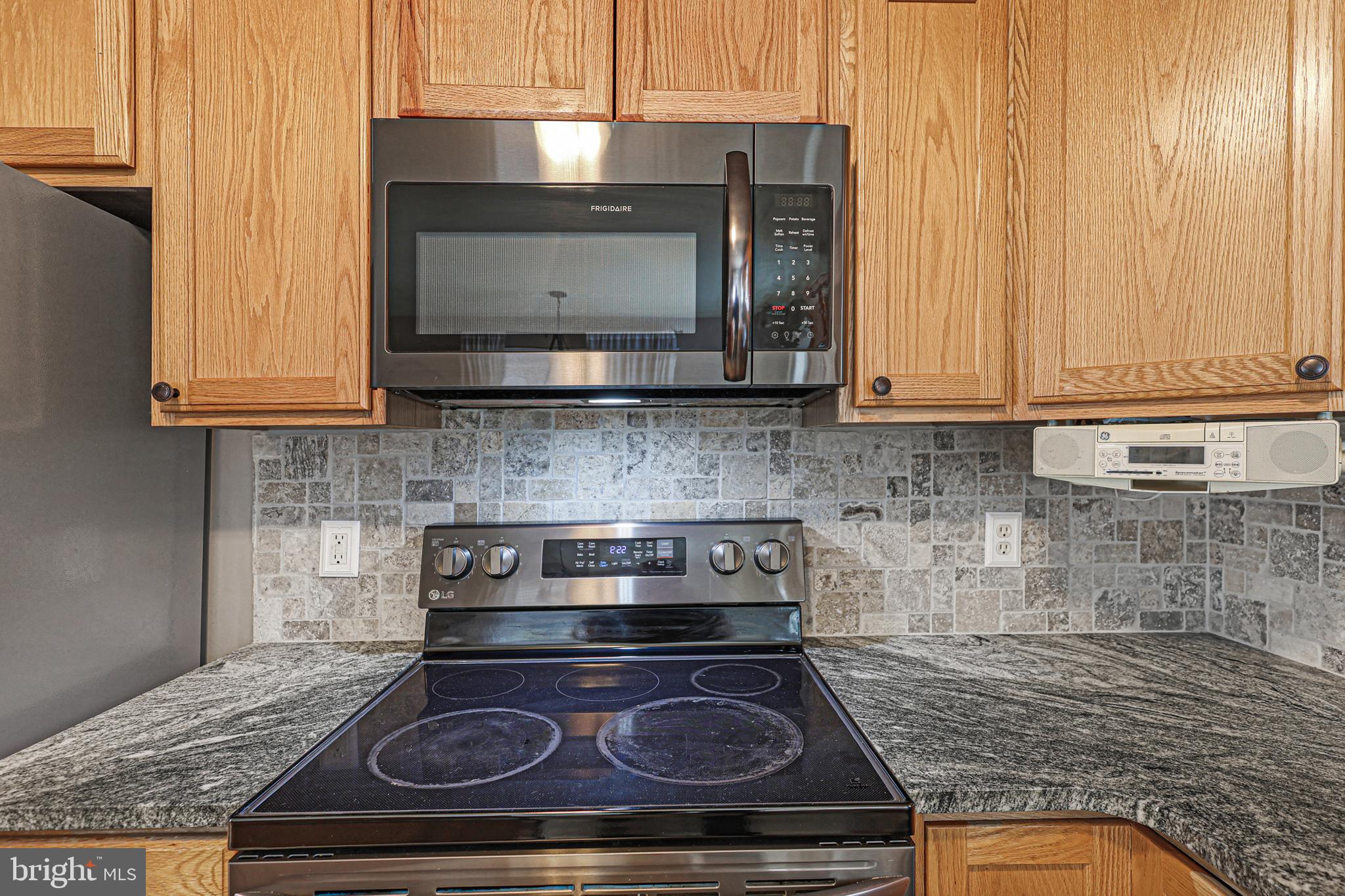 2021 Frostburg Road Frostburg, MD 21532 - Photo 25 of 67 a kitchen with granite countertop wood cabinets and a stove top oven