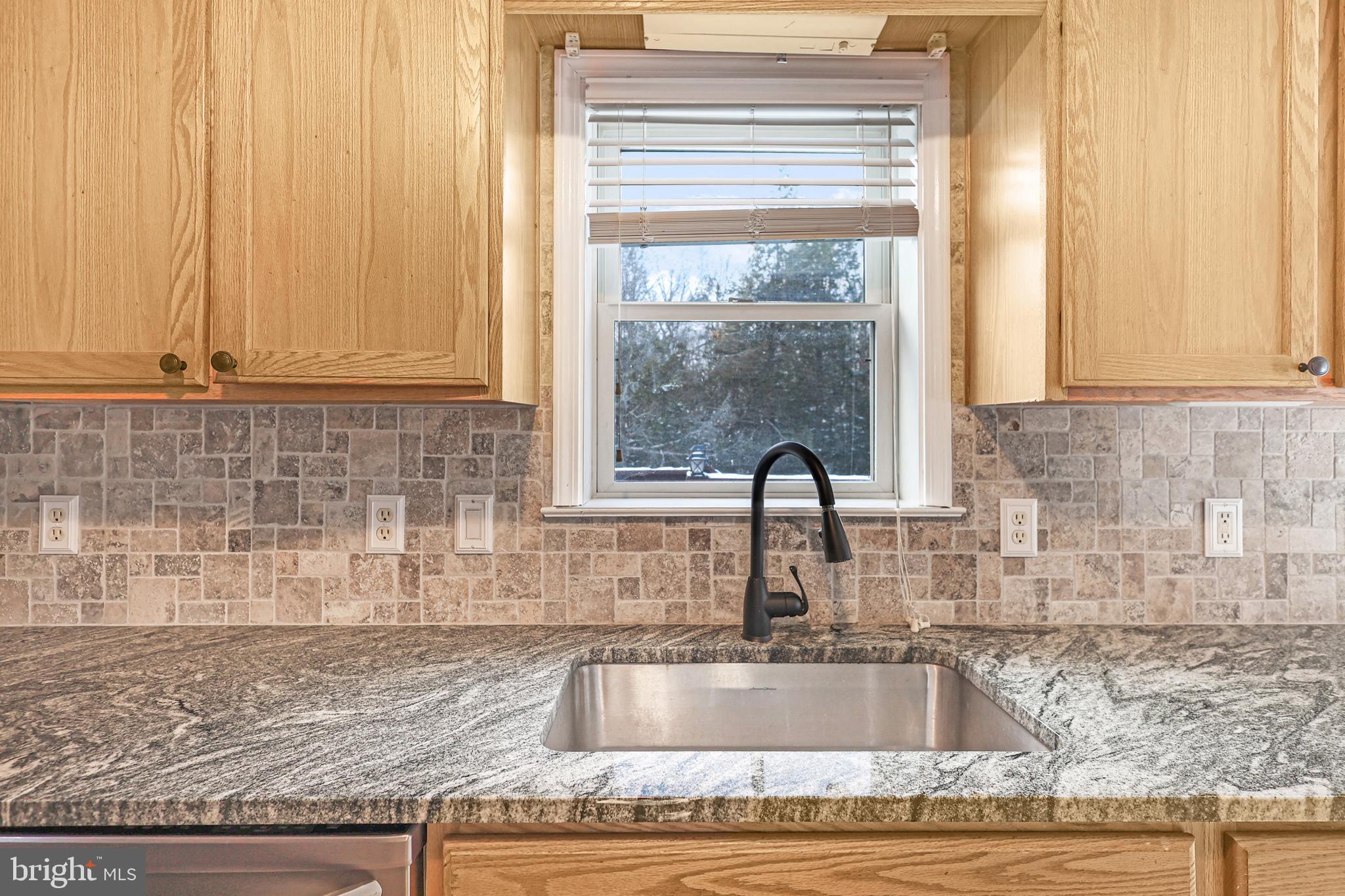 2021 Frostburg Road Frostburg, MD 21532 - Photo 26 of 67 a kitchen with granite countertop a sink and a wooden cabinets