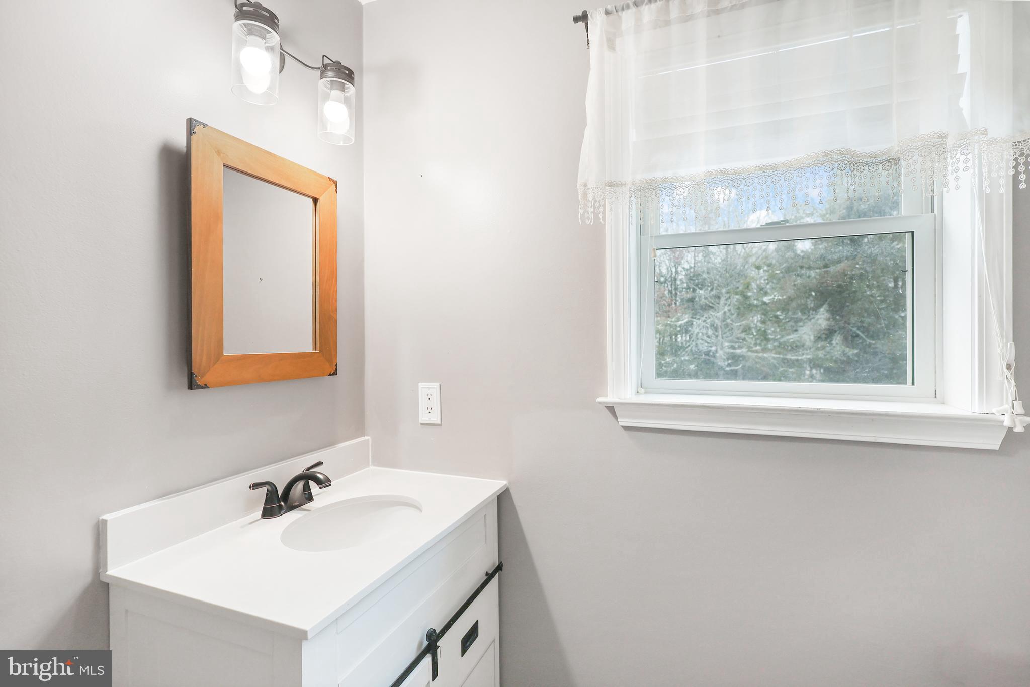 2021 Frostburg Road Frostburg, MD 21532 - Photo 27 of 67 a bathroom with a sink and a mirror