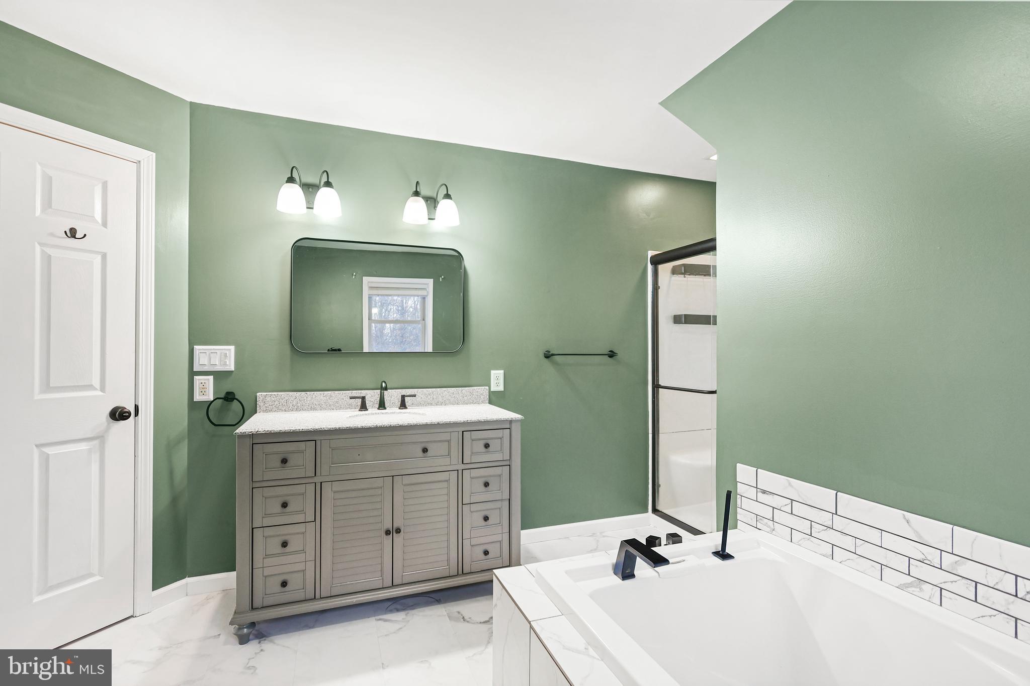 2021 Frostburg Road Frostburg, MD 21532 - Photo 37 of 67 a bathroom with a tub sink and mirror