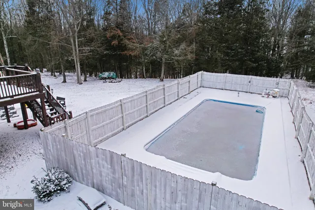 a view of a patio with table and chairs with wooden fence