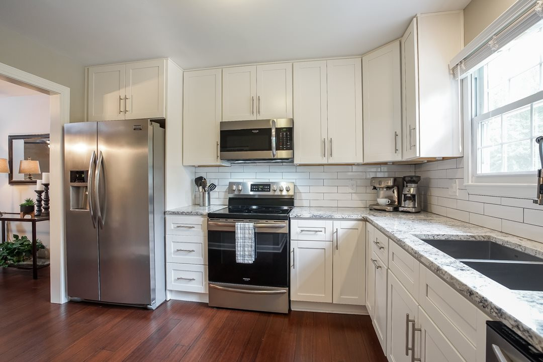 1318 Springlawn Court Raleigh, NC 27609 - Photo 8 of 30 Frigidaire Gallery stainless appliances. Electric smooth top range with microwave. Refrigerator with ice maker included. Kitchen