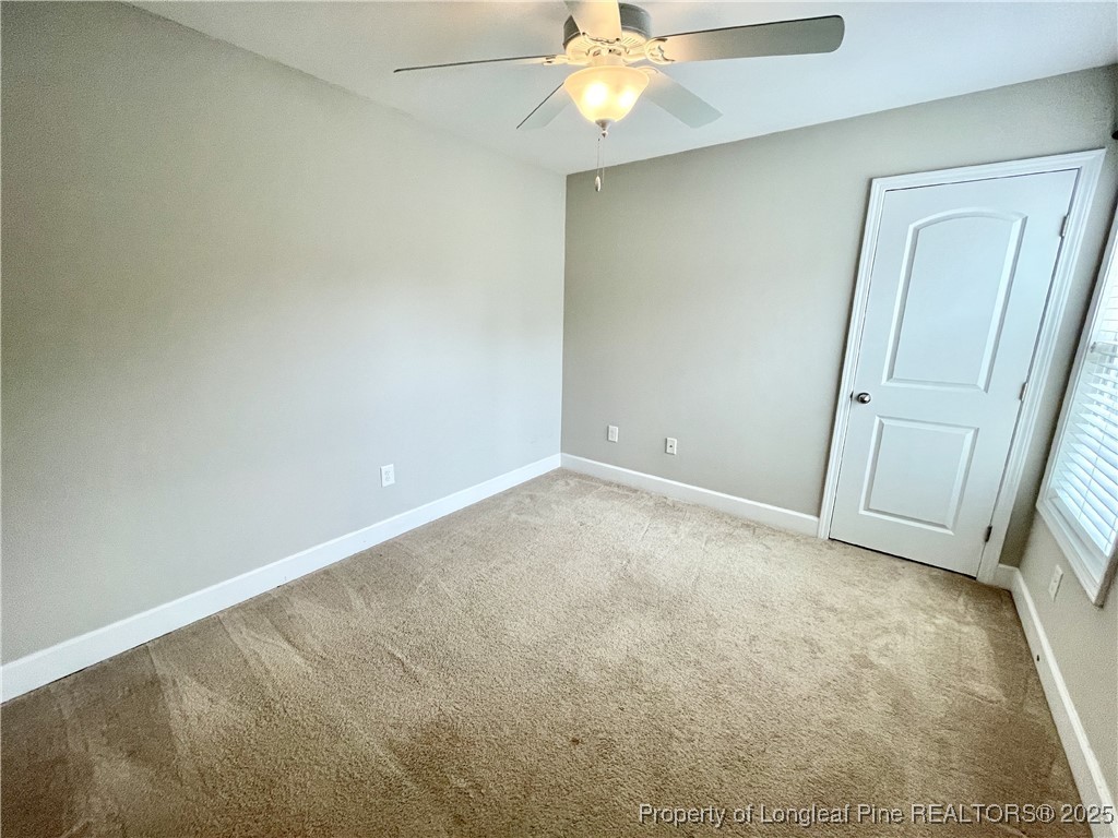 148 Pine Hawk Drive Spring Lake, NC 28390 - Photo 13 of 22 an empty room with a chandelier fan