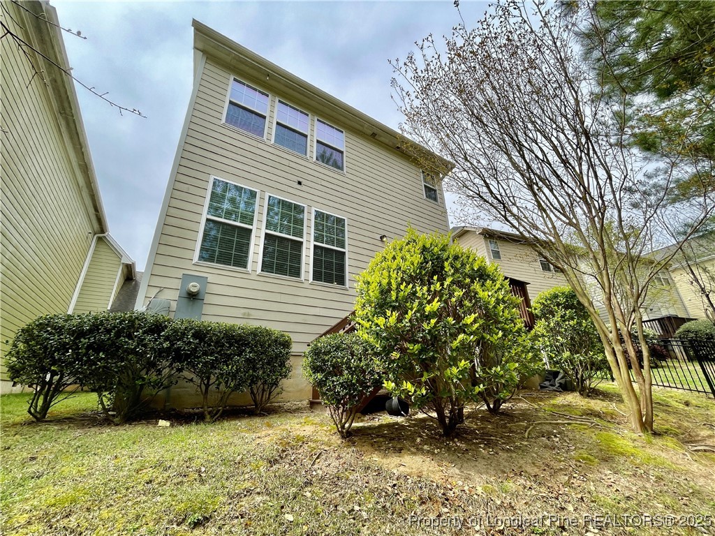 148 Pine Hawk Drive Spring Lake, NC 28390 - Photo 19 of 22 a view of a backyard with plants and large tree