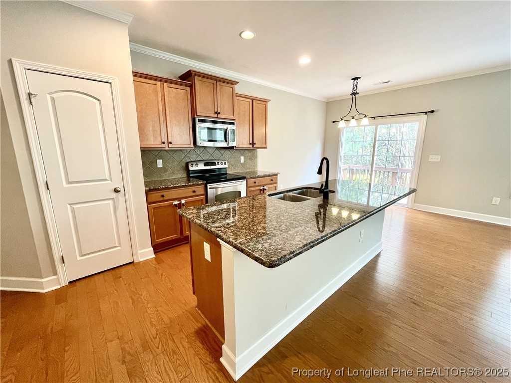 148 Pine Hawk Drive Spring Lake, NC 28390 - Photo 6 of 22 a kitchen with stainless steel appliances granite countertop a refrigerator a stove top oven a sink and dishwasher