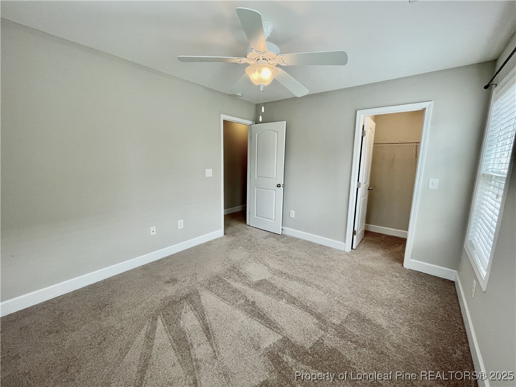 148 Pine Hawk Drive Spring Lake, NC 28390 - Photo 10 of 22 an empty room with closet and a chandelier fan