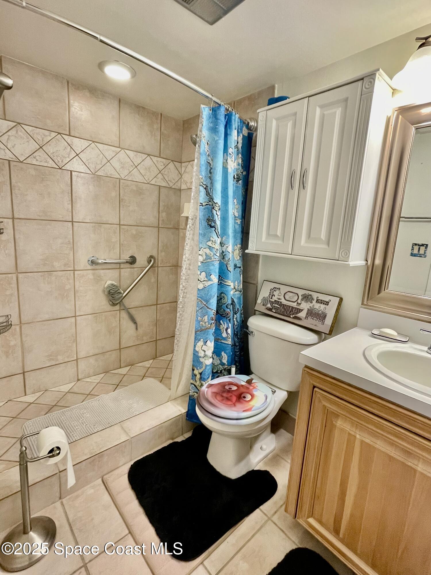 594 North Wickham Road, Unit 2 Melbourne, FL 32935 - Photo 18 of 42 a bathroom with a sink and a mirror