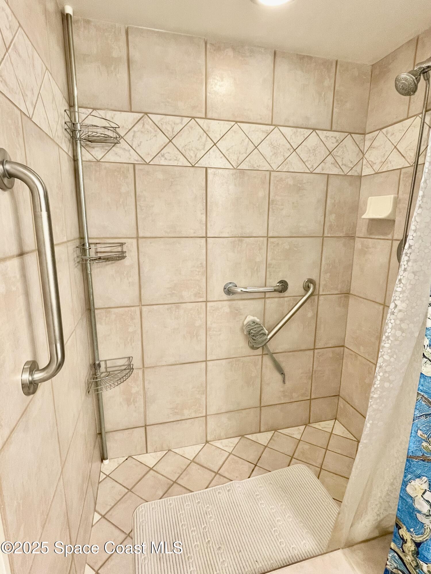 594 North Wickham Road, Unit 2 Melbourne, FL 32935 - Photo 19 of 42 a bathroom with a shower