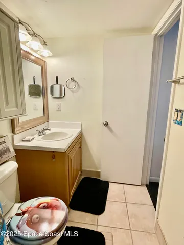 a bathroom with a sink a toilet a mirror and vanity