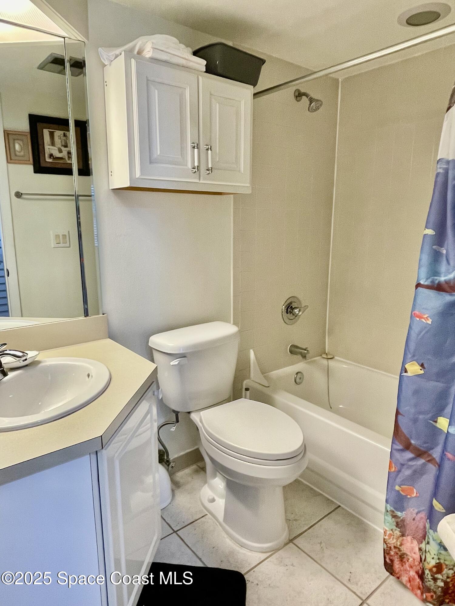 594 North Wickham Road, Unit 2 Melbourne, FL 32935 - Photo 23 of 42 a bathroom with a sink a toilet and shower