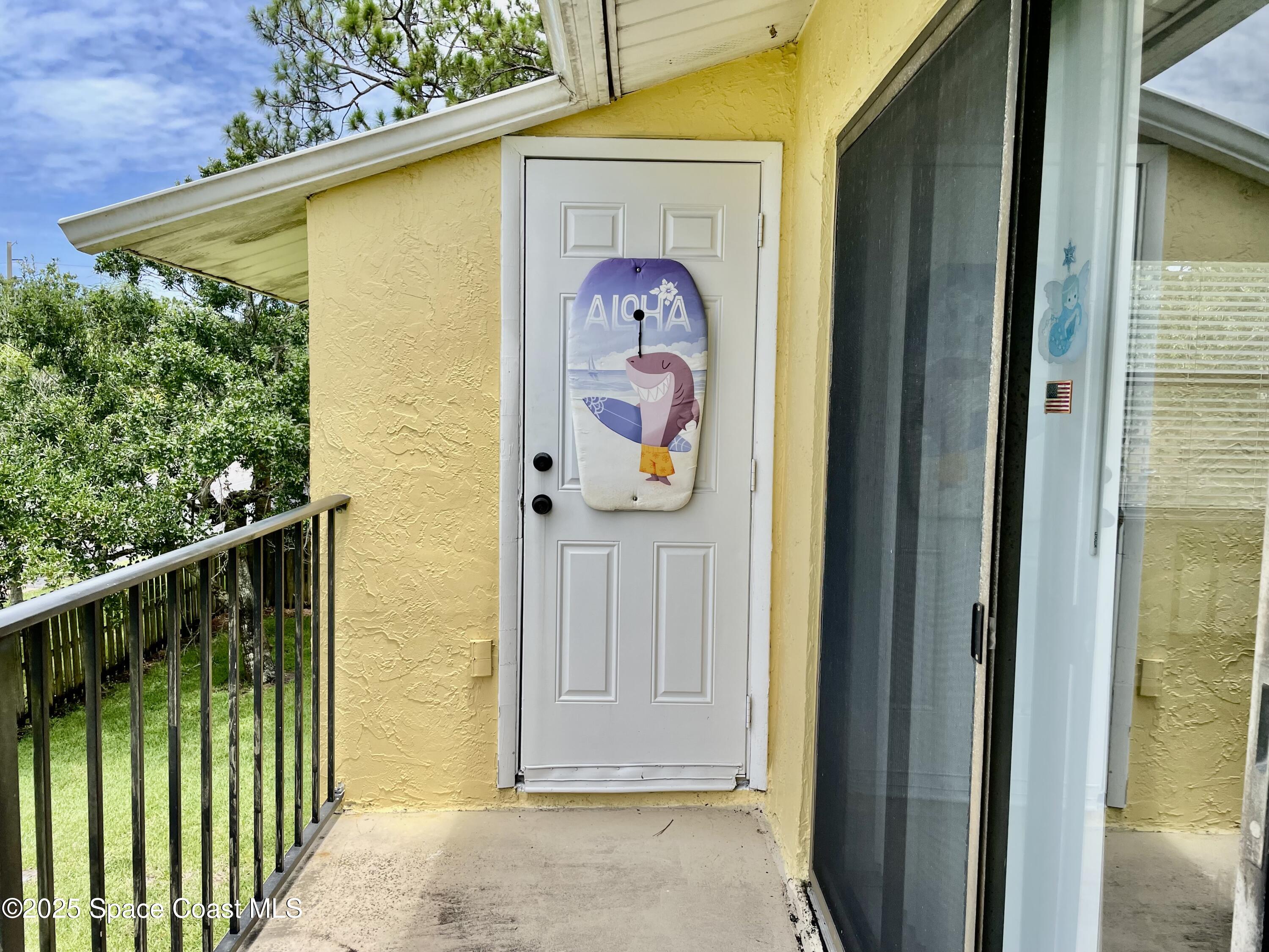 594 North Wickham Road, Unit 2 Melbourne, FL 32935 - Photo 25 of 42 a front view of a house with garden