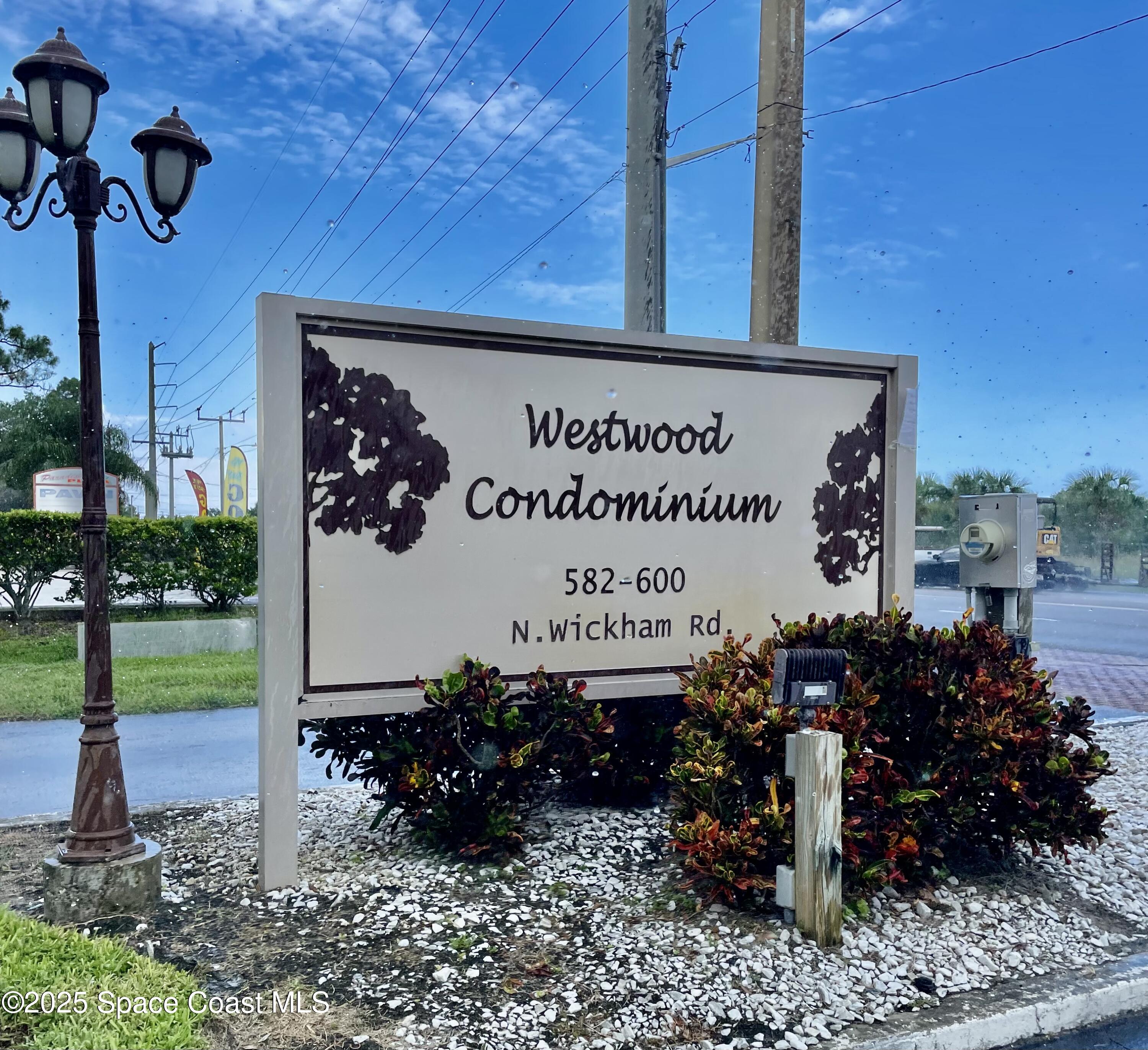 594 North Wickham Road, Unit 2 Melbourne, FL 32935 - Photo 29 of 42 a sign on the side of a building