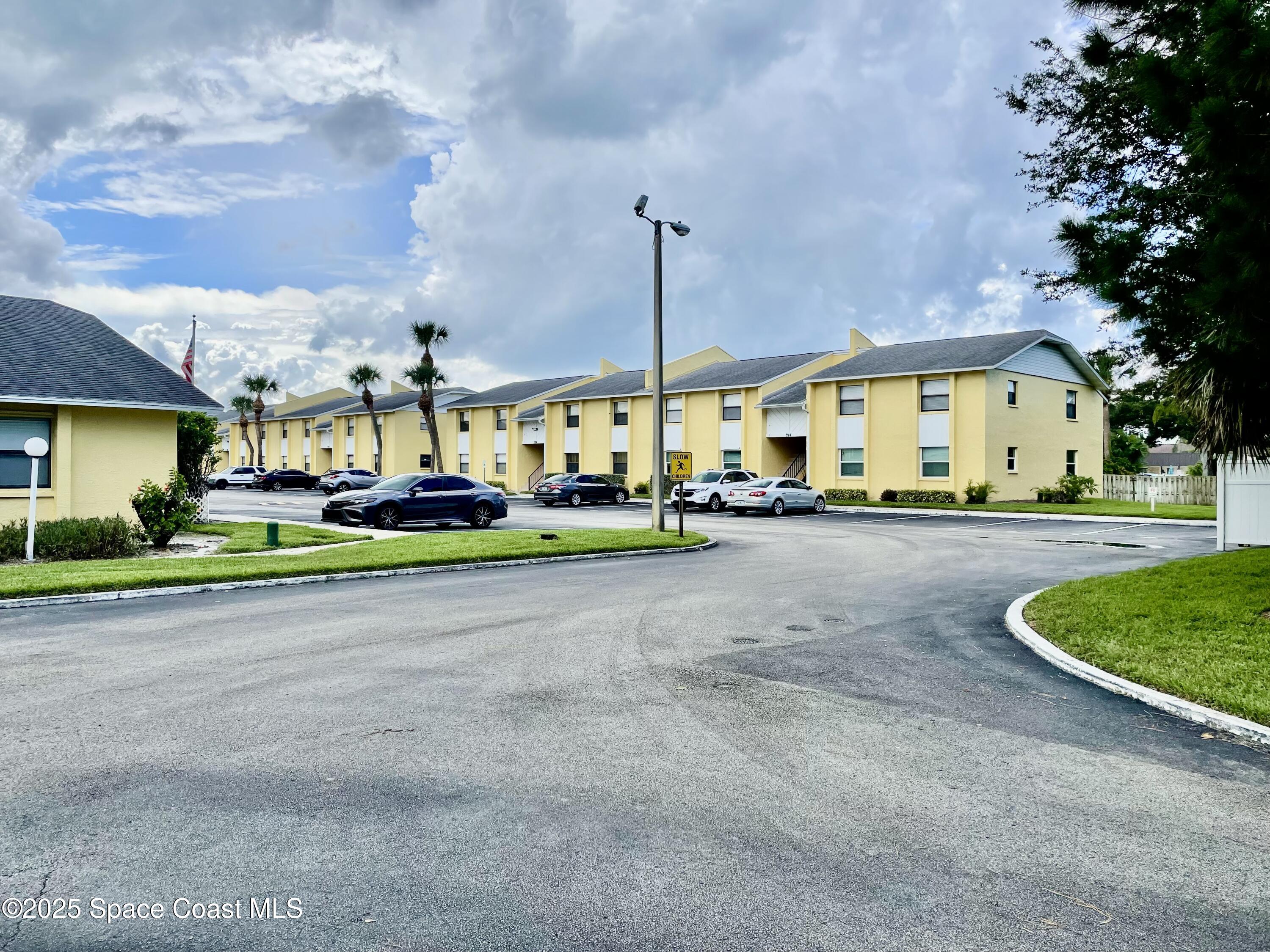 594 North Wickham Road, Unit 2 Melbourne, FL 32935 - Photo 31 of 42 a view of a street with cars parked