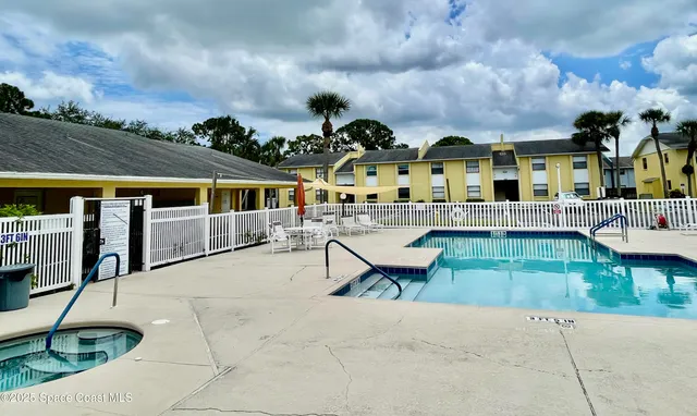 a view of house with a garden and sitting area