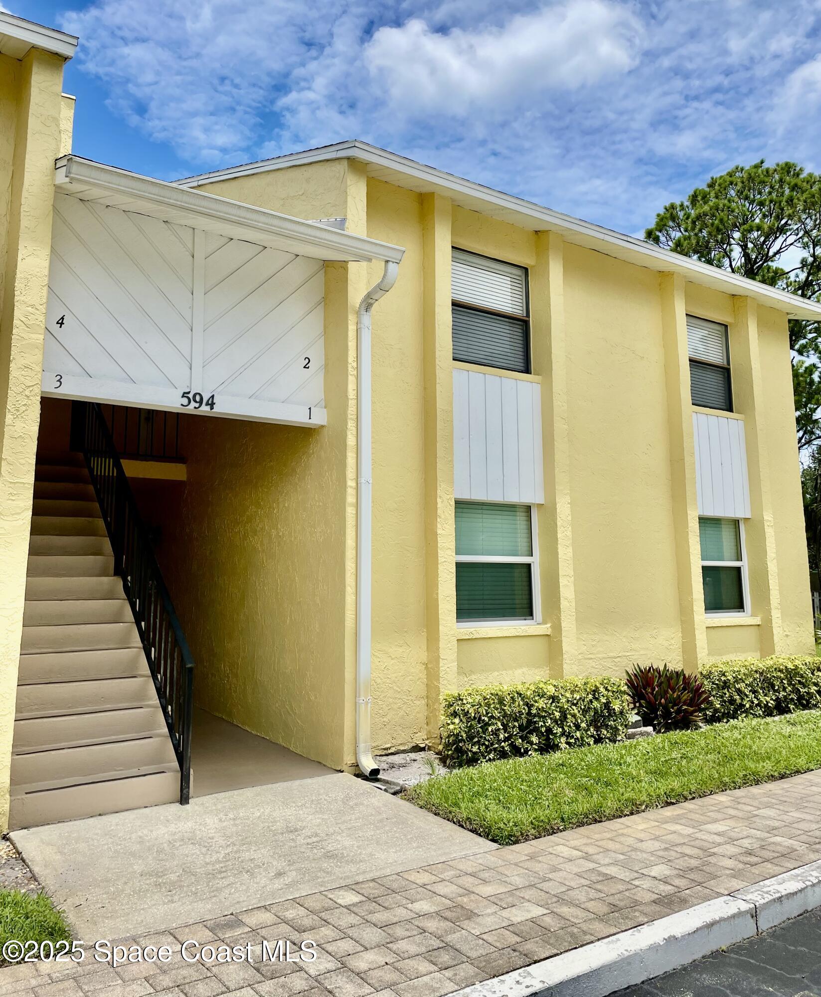 594 North Wickham Road, Unit 2 Melbourne, FL 32935 - Photo 42 of 42 a front view of a house with a garage