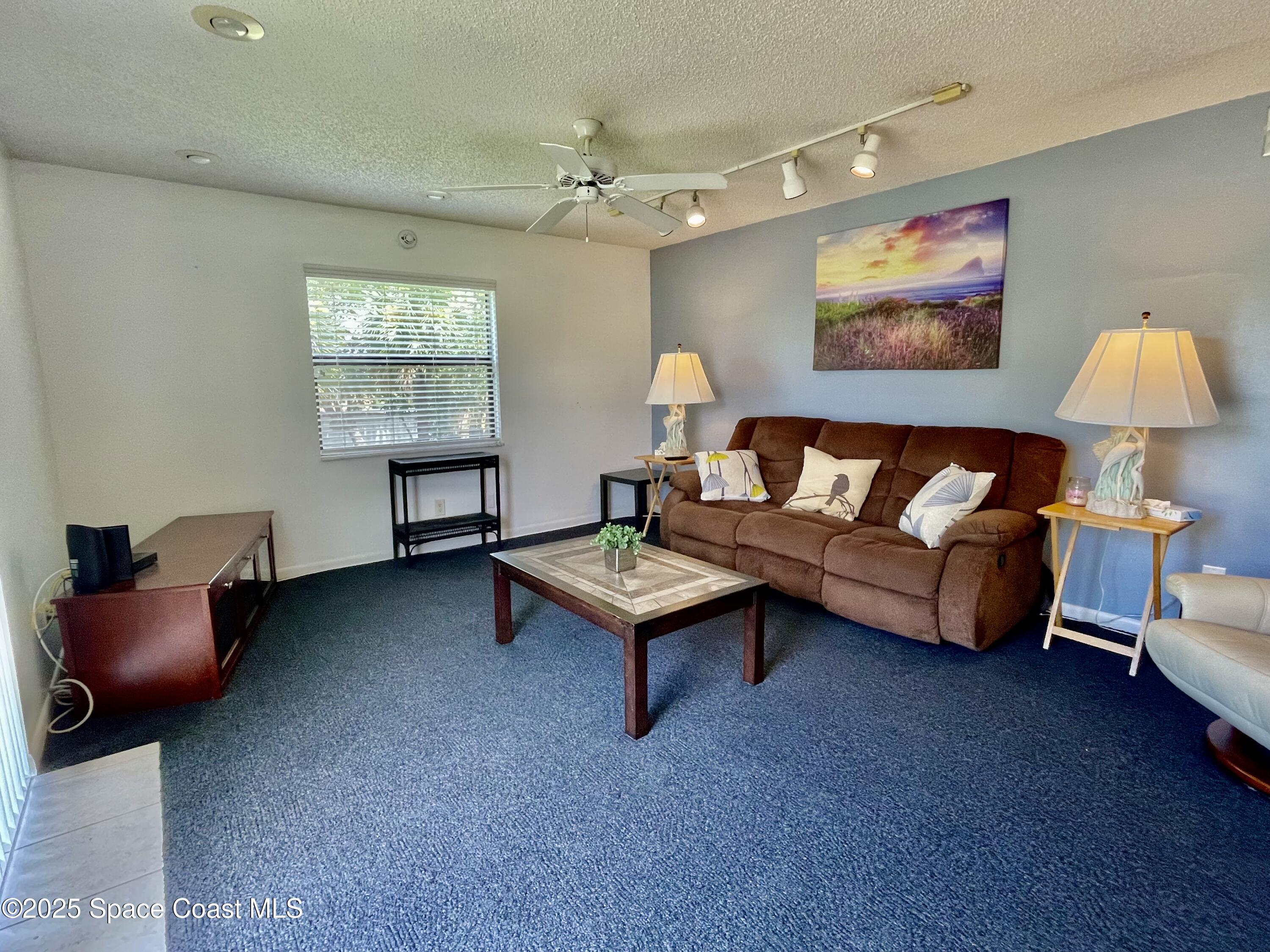 594 North Wickham Road, Unit 2 Melbourne, FL 32935 - Photo 7 of 42 a living room with furniture and a window