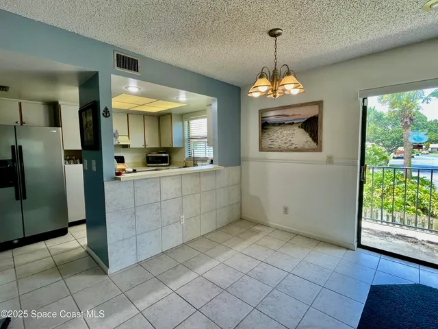 a view of a kitchen with a sink and a window