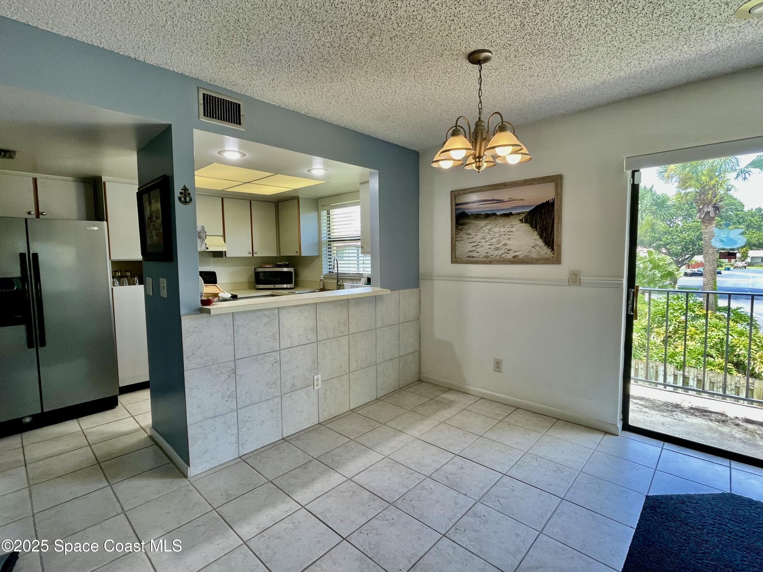 594 North Wickham Road, Unit 2 Melbourne, FL 32935 - Photo 9 of 42 a view of a kitchen with a sink and a window