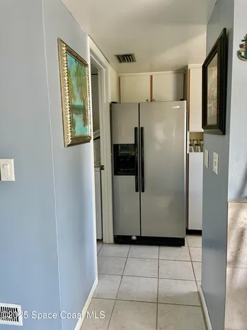 a refrigerator freezer sitting inside of a kitchen