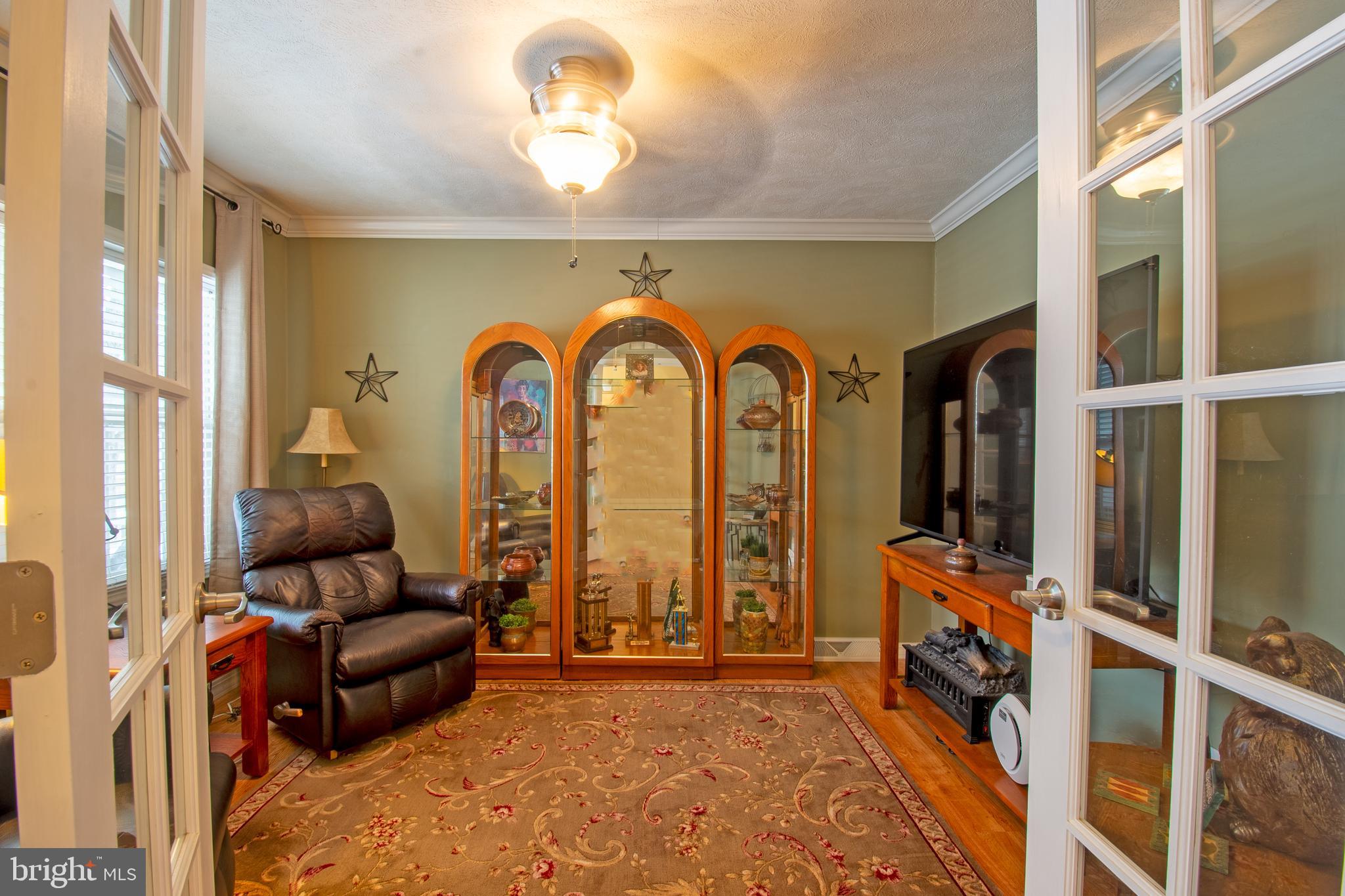 148 Bluebell Drive, Unit 75 Magnolia, DE 19962 - Photo 11 of 32 a living room with furniture and a large window