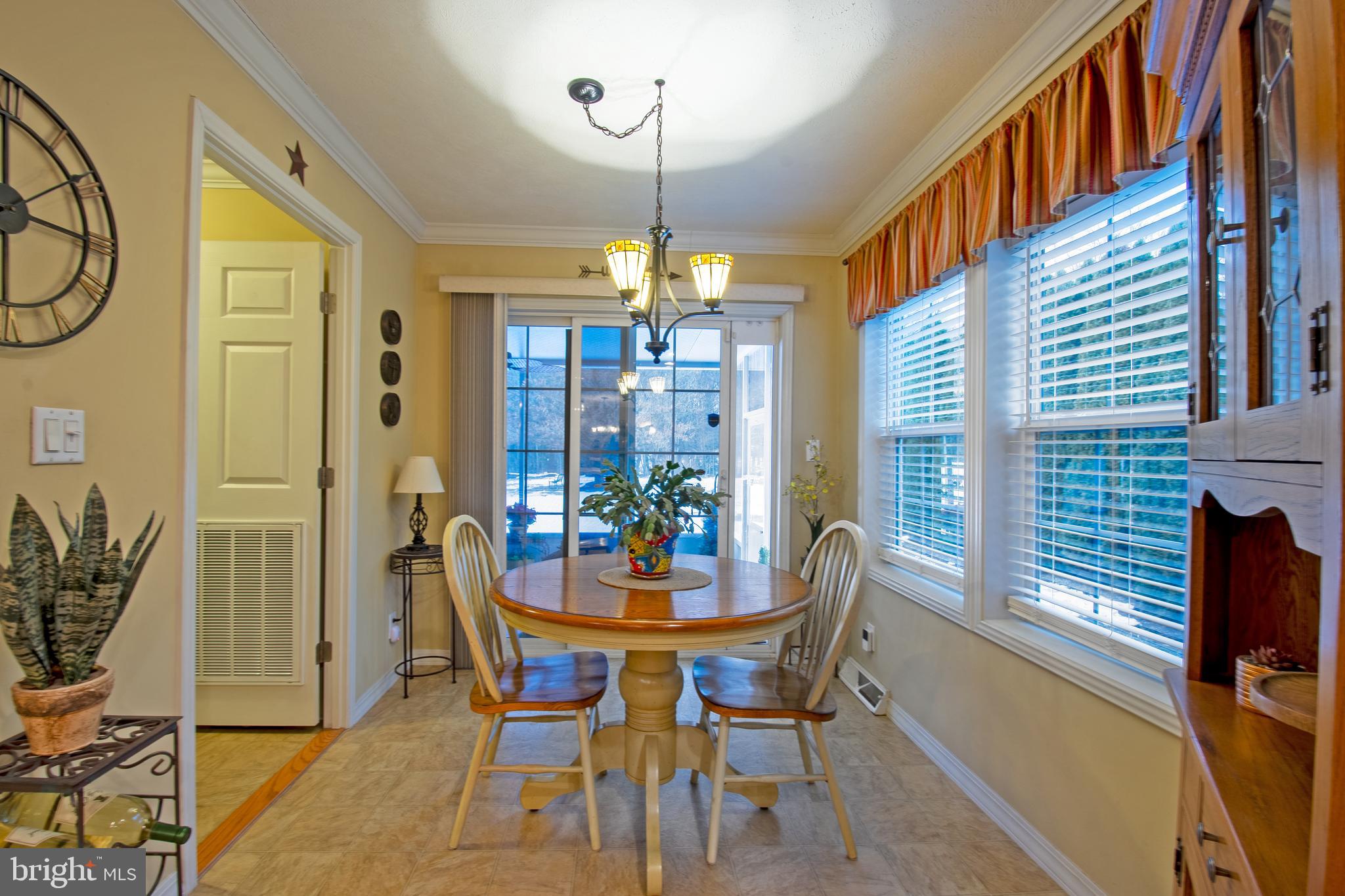 148 Bluebell Drive, Unit 75 Magnolia, DE 19962 - Photo 23 of 32 a dining room with furniture a chandelier and wooden floor