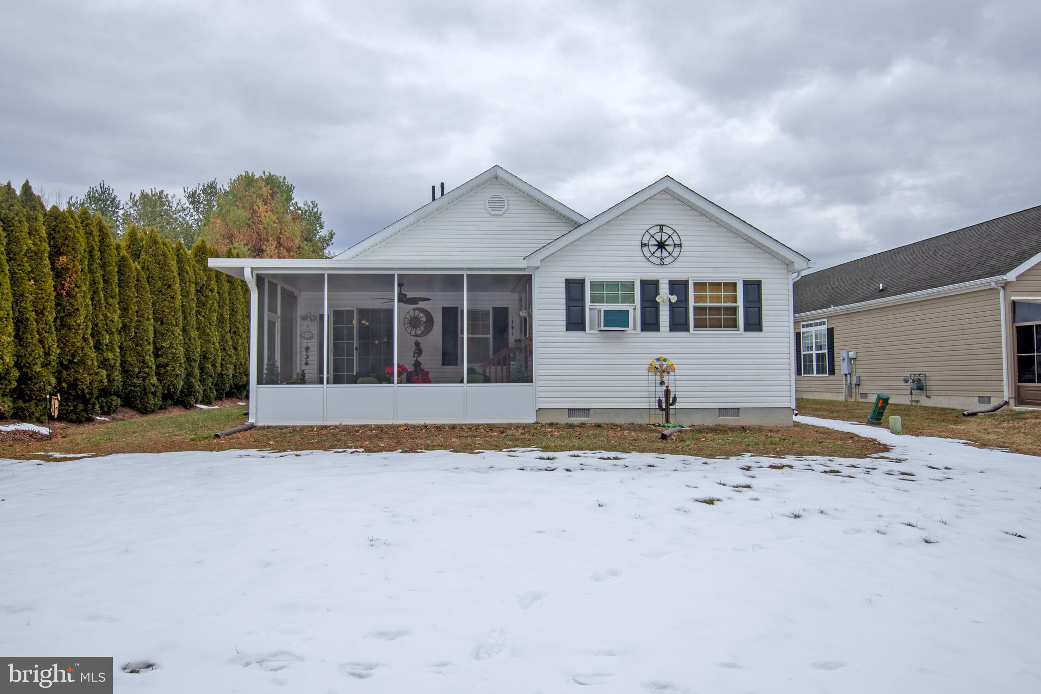 148 Bluebell Drive, Unit 75 Magnolia, DE 19962 - Photo 3 of 32 a front view of a house with a yard and garage