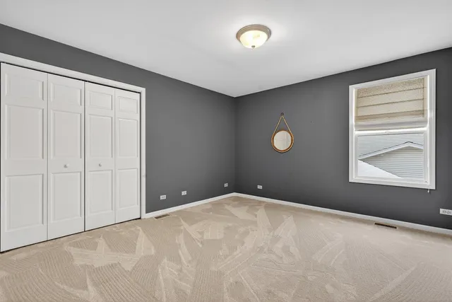 an empty room with windows and closet