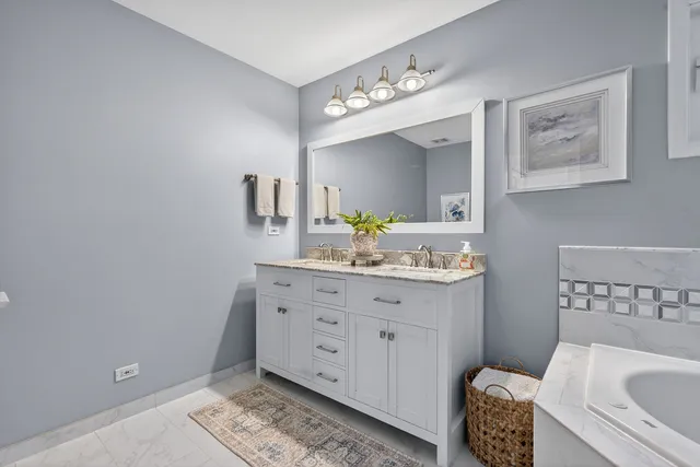 a bathroom with a sink a toilet and mirror